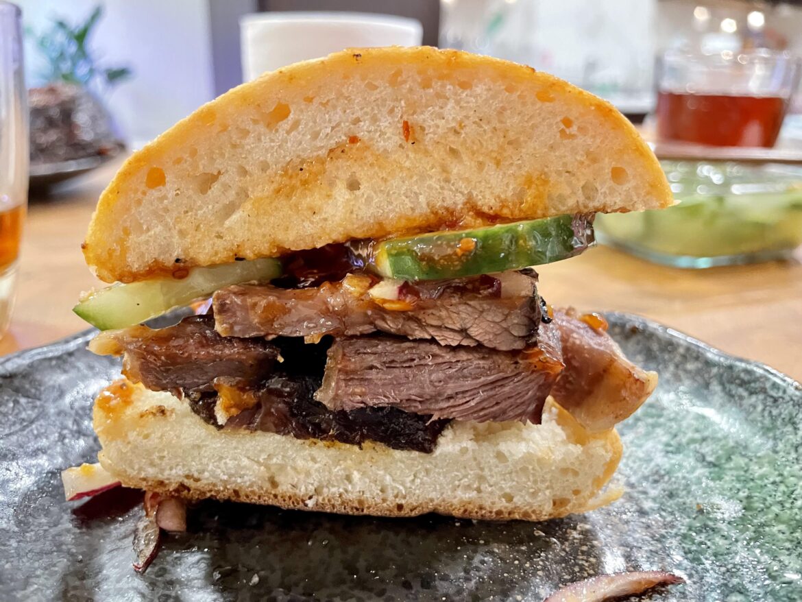 BBQ Beef Rib Sandwich with homemade Bun, Pickles, and BBQ Sauce