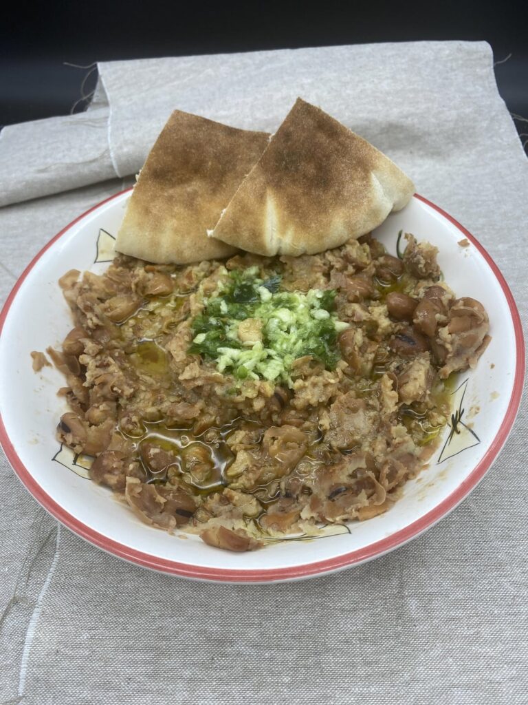 Breakfast “Fuul” Fava beans with garlic, jalapeños and olive oil, served with homemade pita bread
