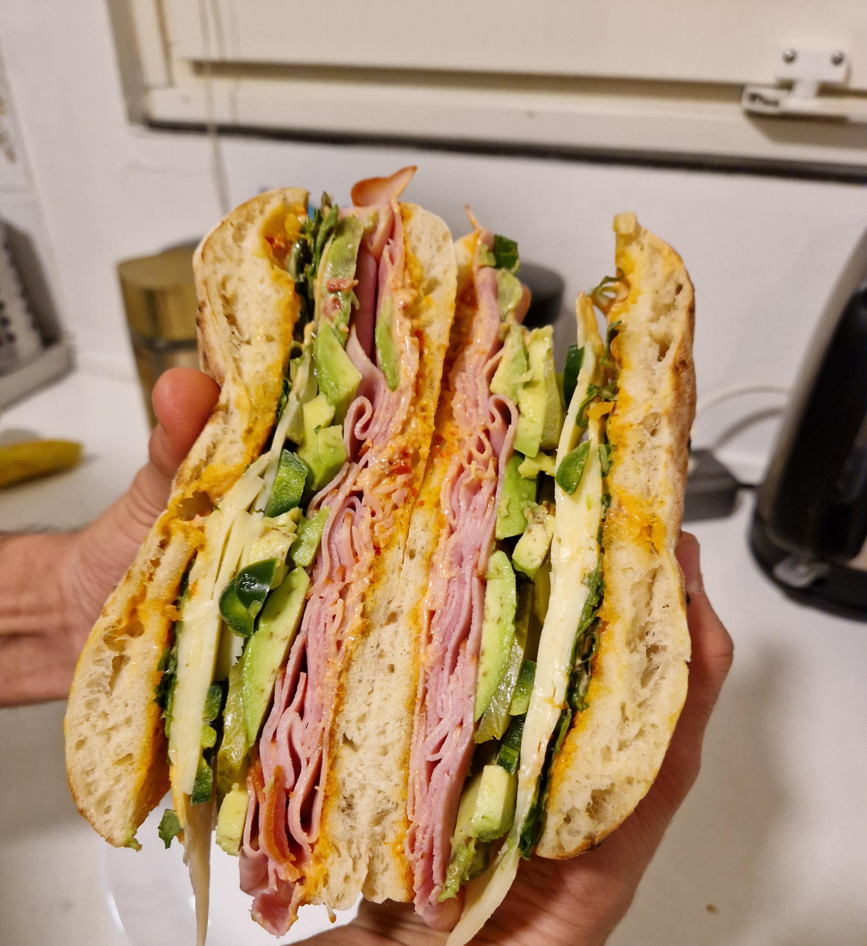 Smoked ham sandwich with avocado, aged cheese, pickles, jalapeño and rucula. (Toasted bread of