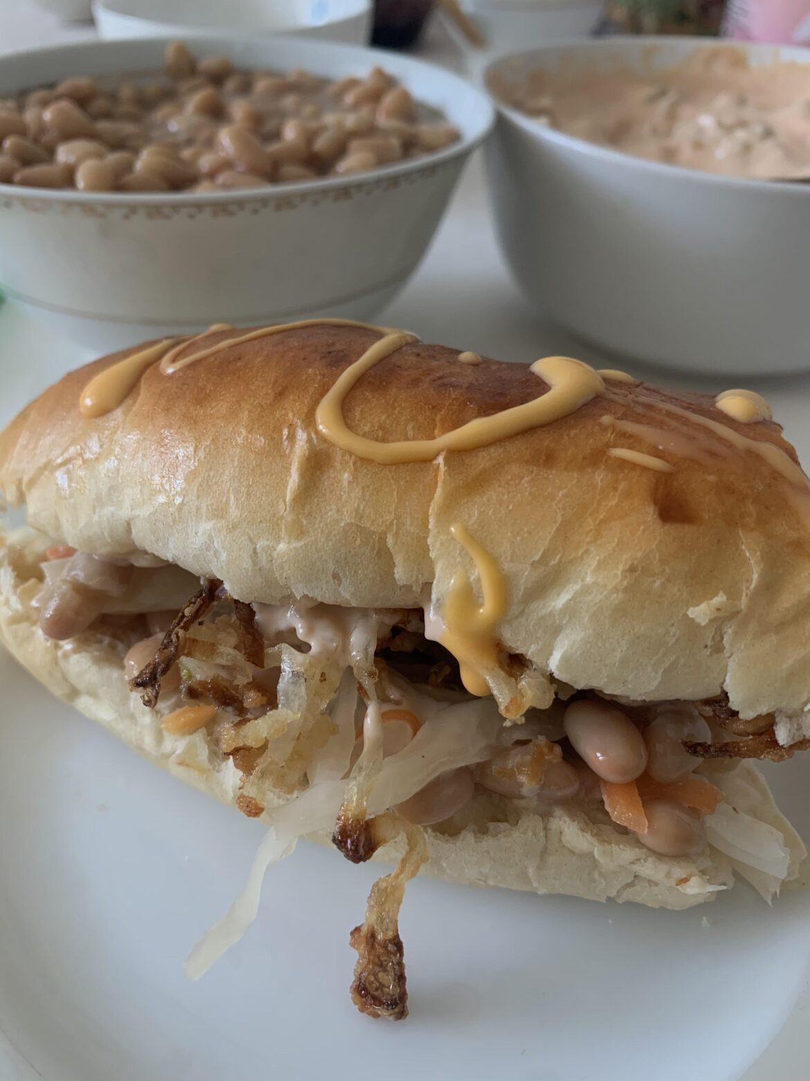 Vegetarian hot-dog with beans & fried onion