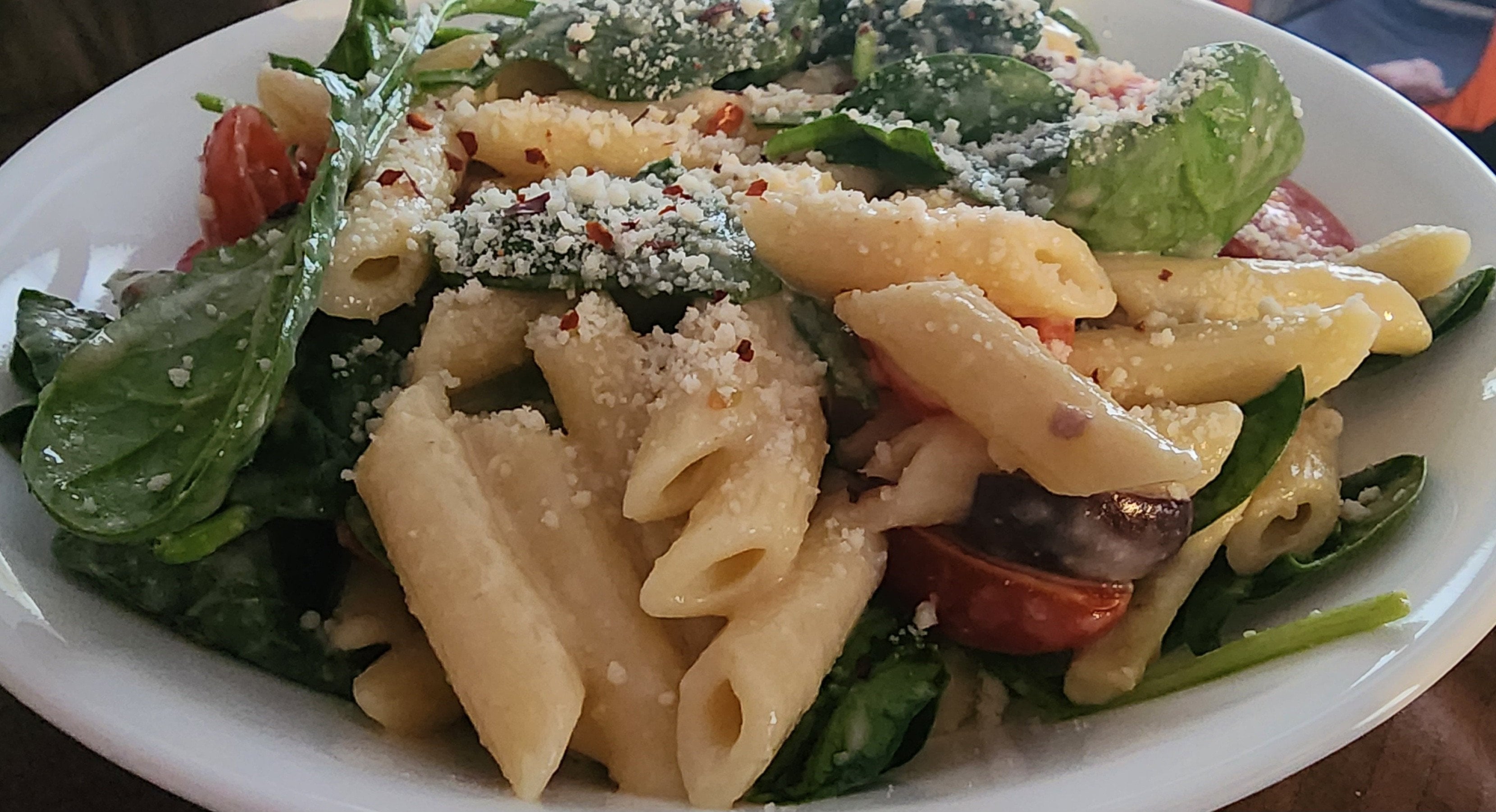 Creamy hummus pasta with cherry tomatoes, artichokes, kalamata olives