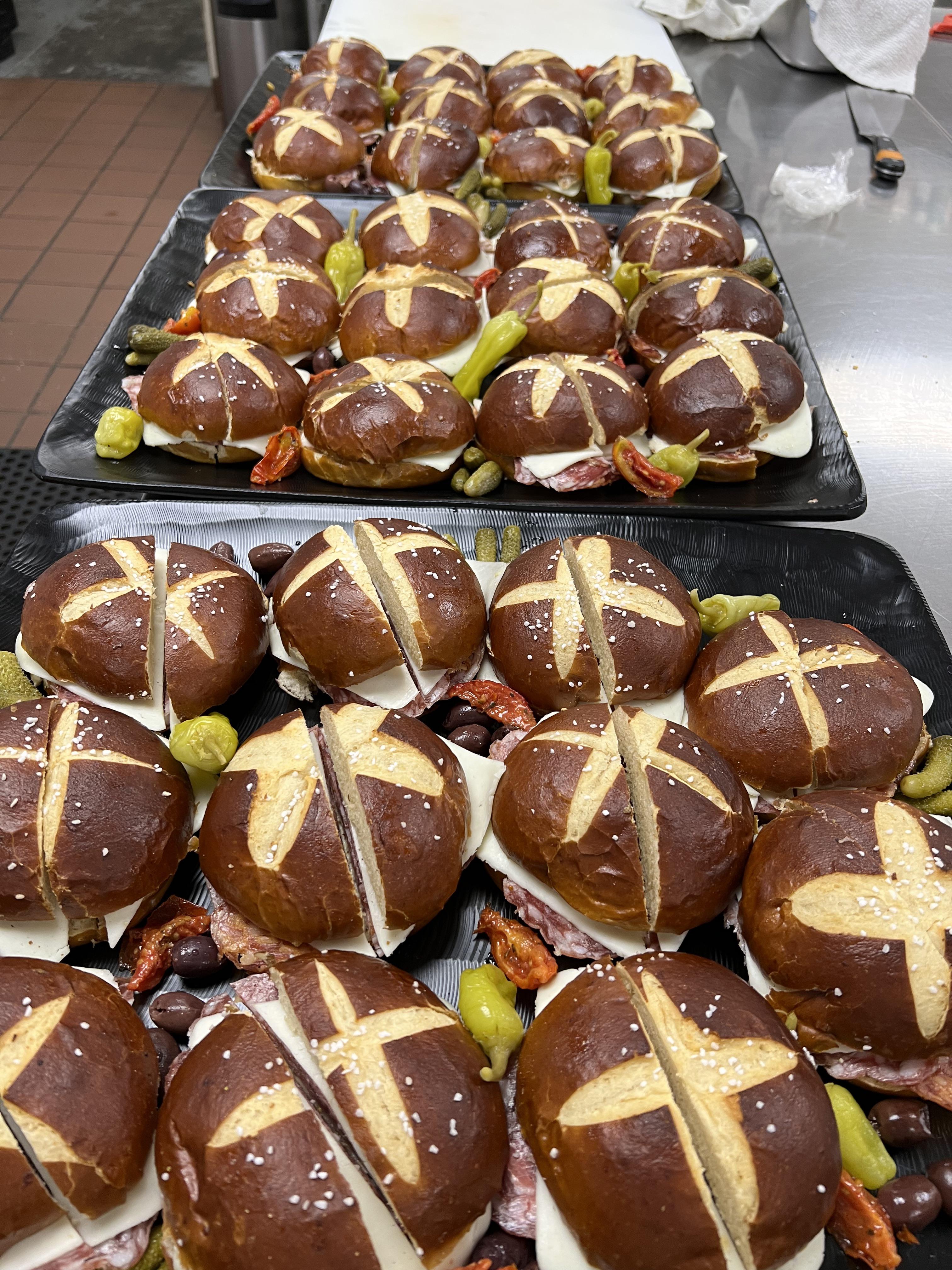 Various salami, mozzarella, whole grain mustard and mayo on a pretzel