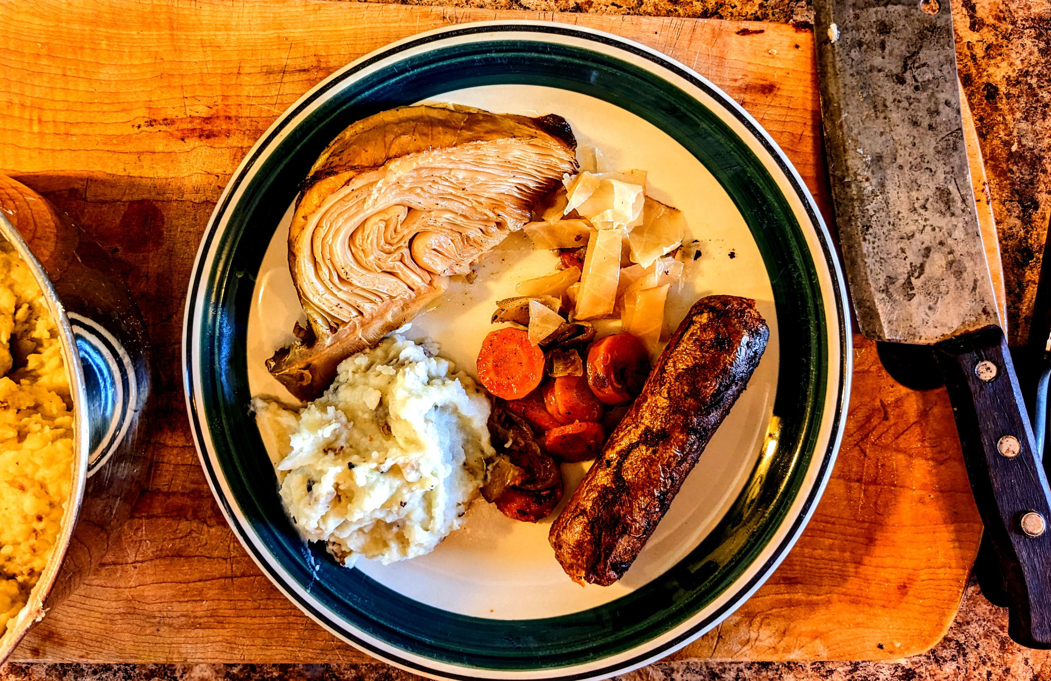 Braised cabbage, onions, & carrots, with BBQ beyond sausage, & mashed