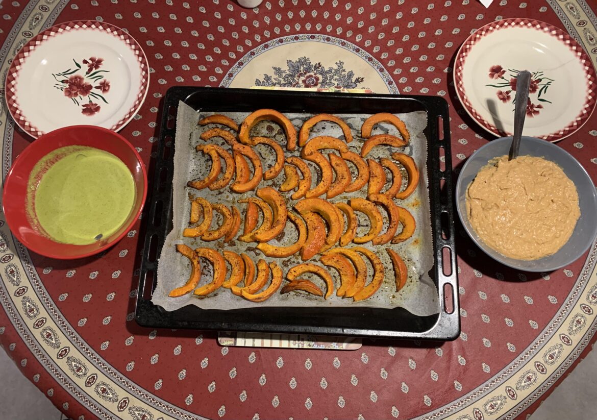Baked pumpkin slices with garlic, cilantro sauce & sundried tomato hummus