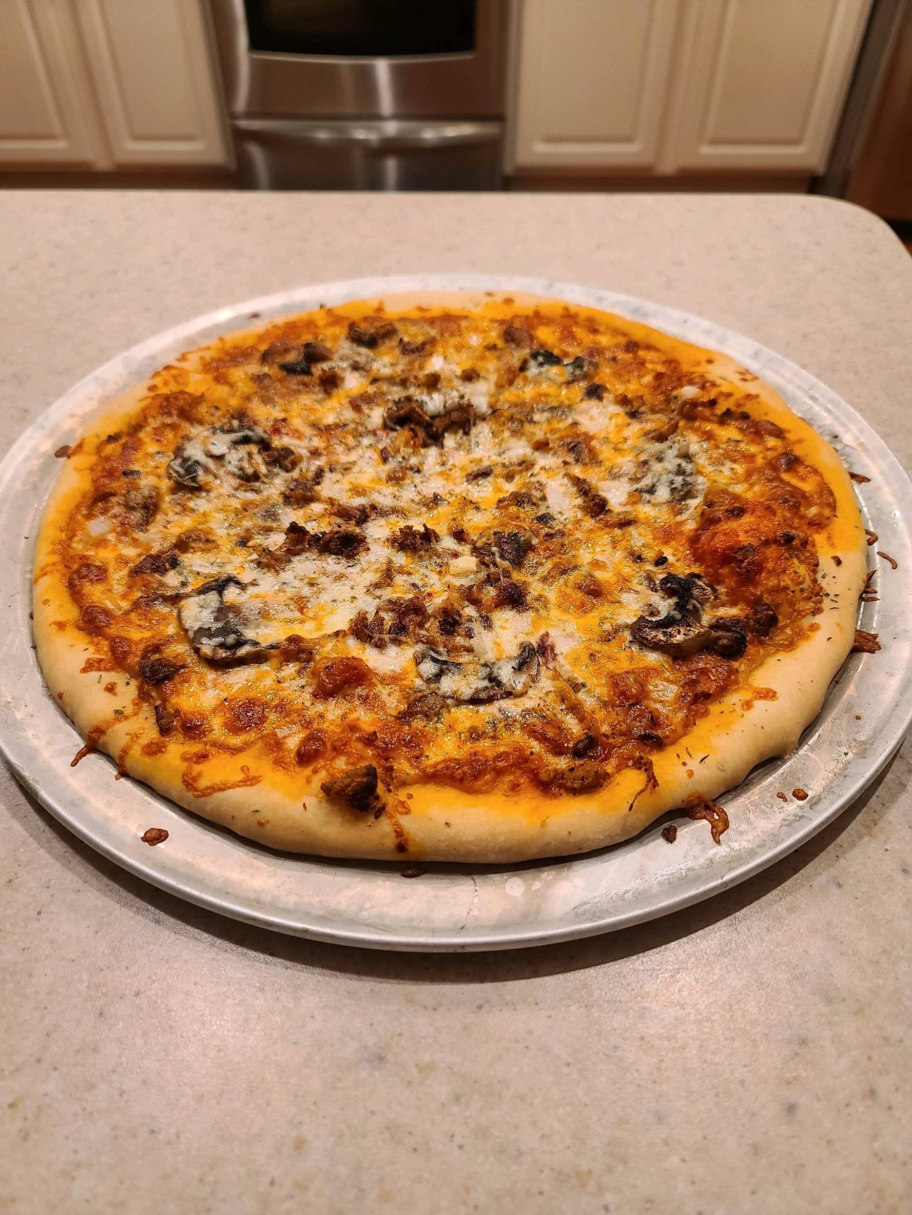 Homeade dough! Pulled pork, spicy marinara, mushroom, onion, and garlic