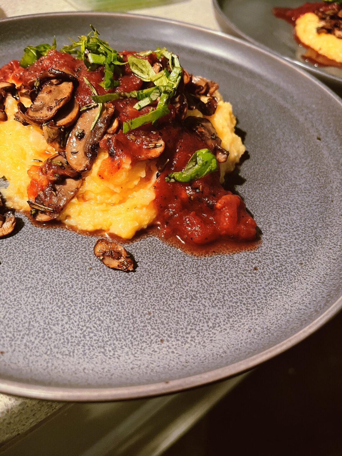 Cheesy polenta with mushrooms and marinara. Flavorful mush meals are my favorite.