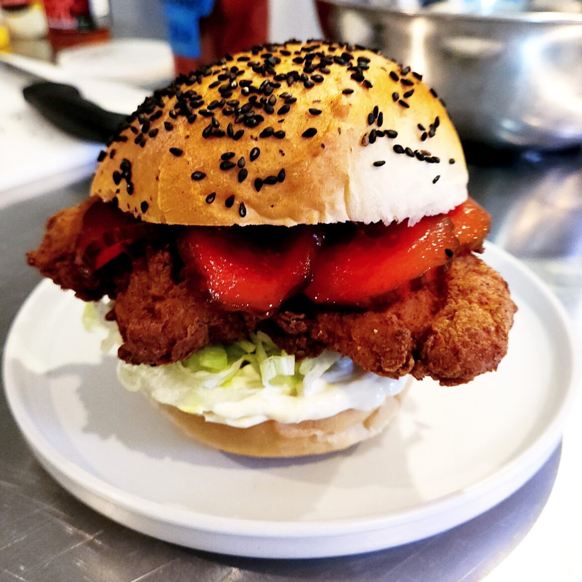 Fried chicken sandwich: cherry / lemonade Kool-Aid quick pickles, Duke's mayo, shreddy letty, fresh homemade black sesame bun