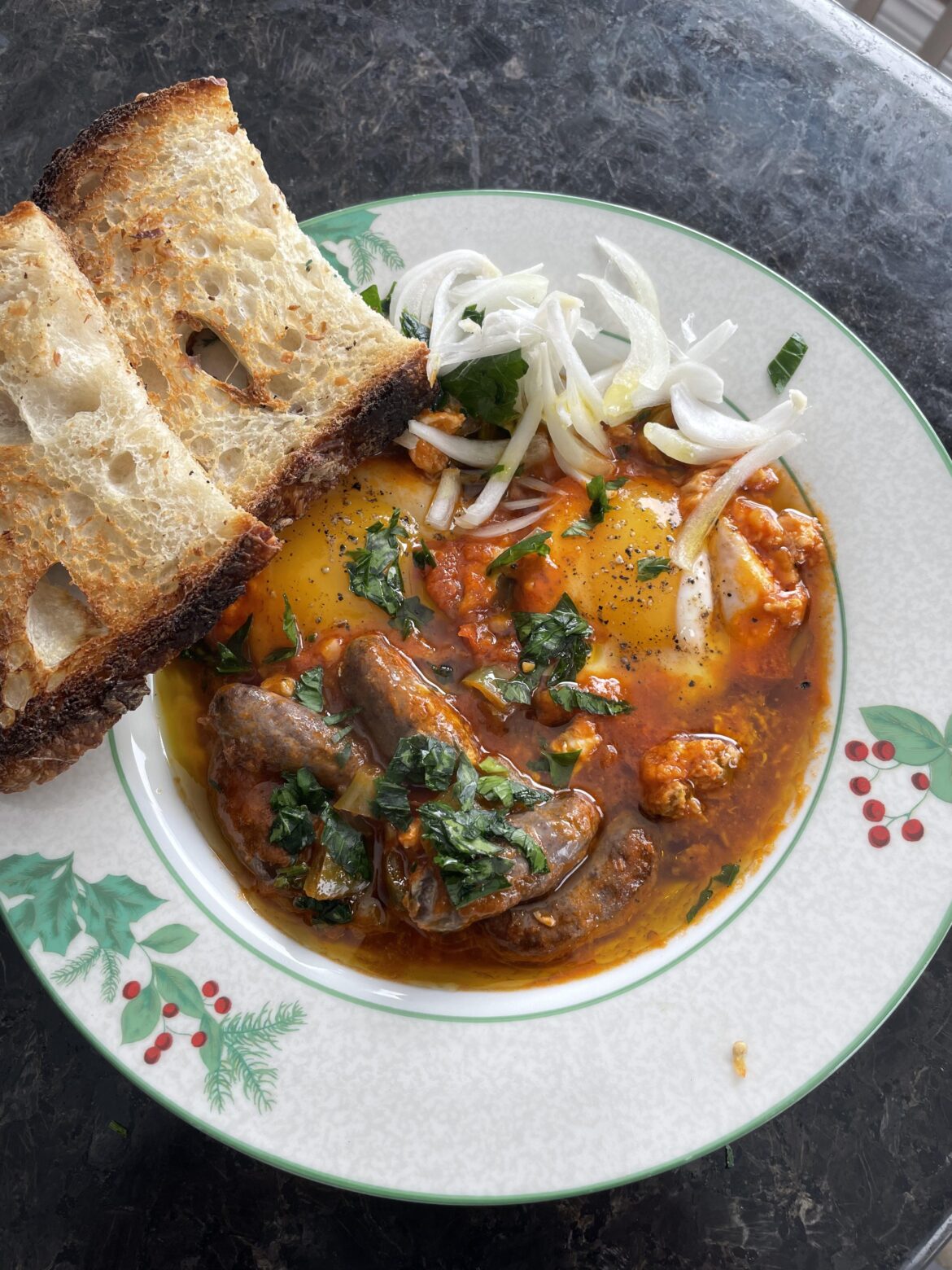 Beef sausages simmered in tomato sauce with sourdough bread (Tunisian Ojja Mergez)