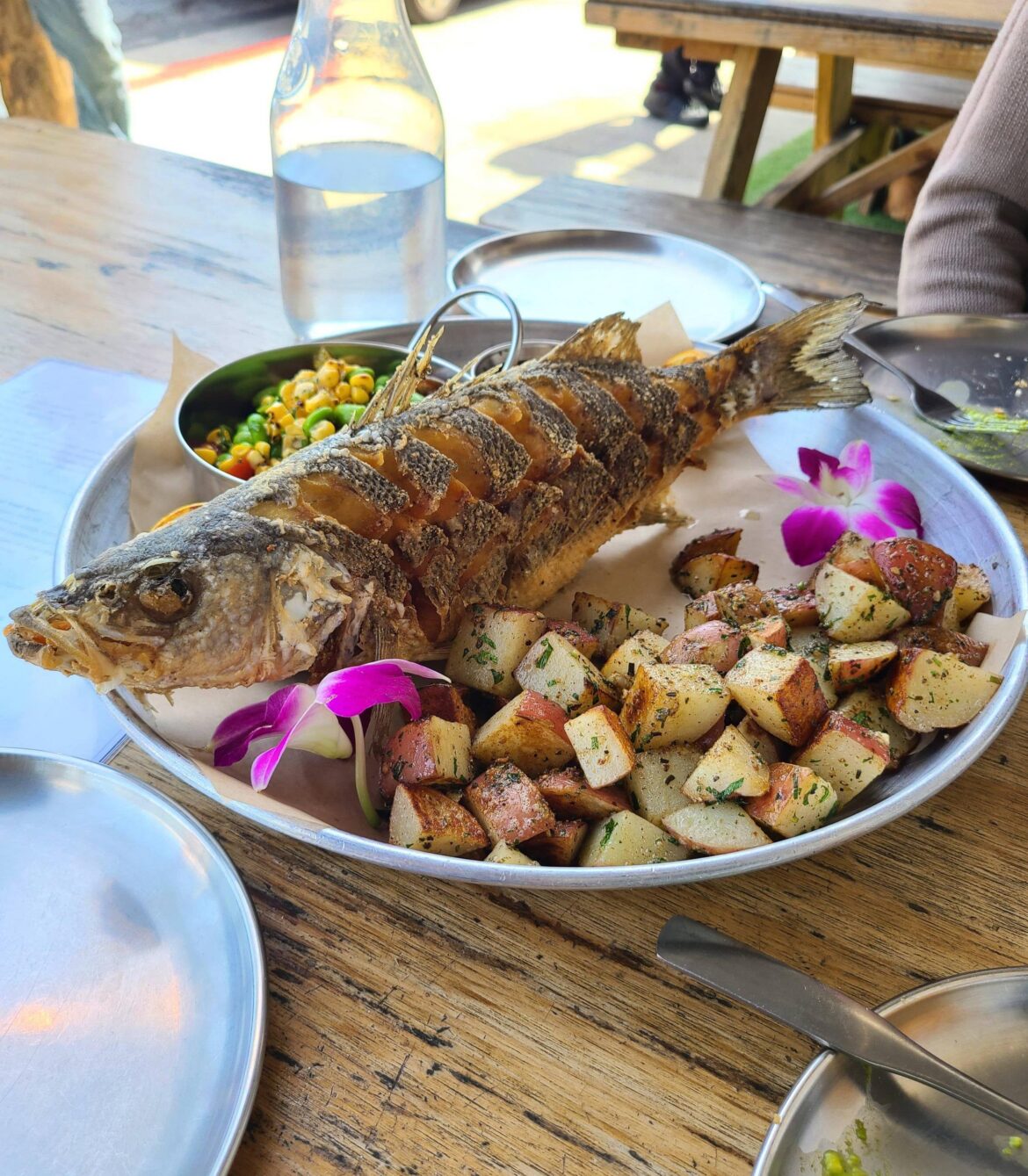 Whole fried branzino with rosemary potatoes and edamame salad from Tangaroa Fish Market