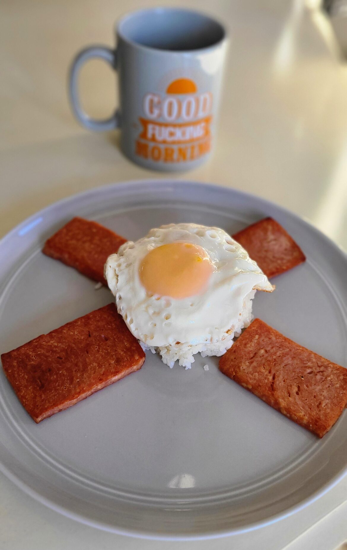 Spam with garlic fried rice with an egg on it.