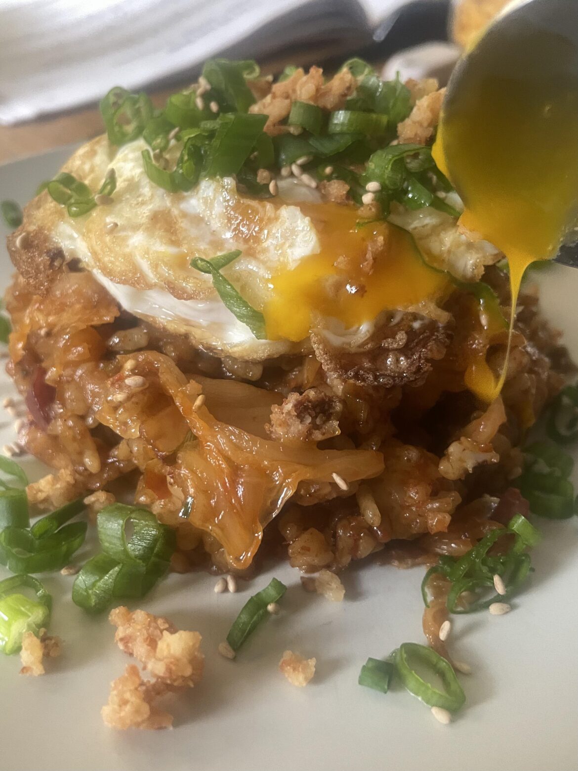 Kimchi bokkeumbap with fried egg and pork crackling