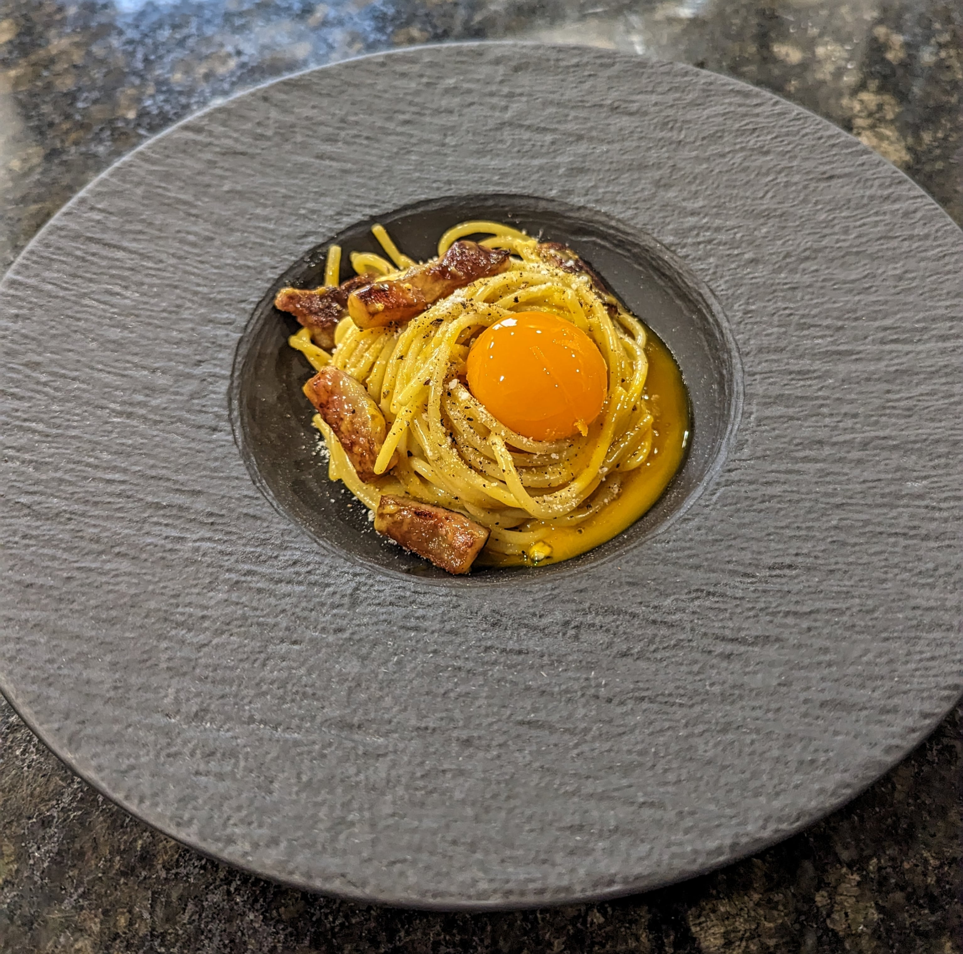 Spaghetti Carbonara with an olive oil poached egg yolk Dining and Cooking