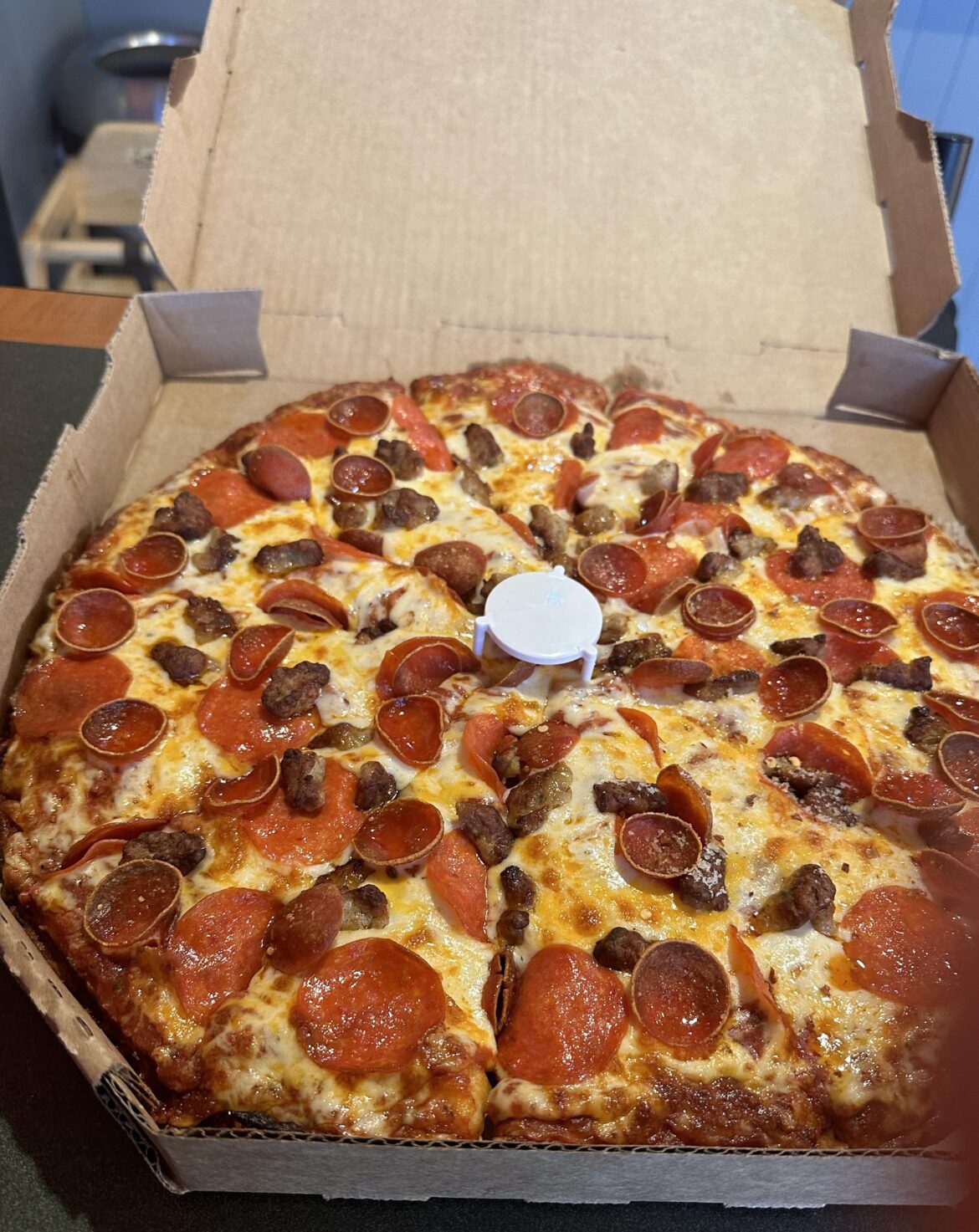 Perfect pepperoni and sausage Round Table pizza with extra cheese and sauce