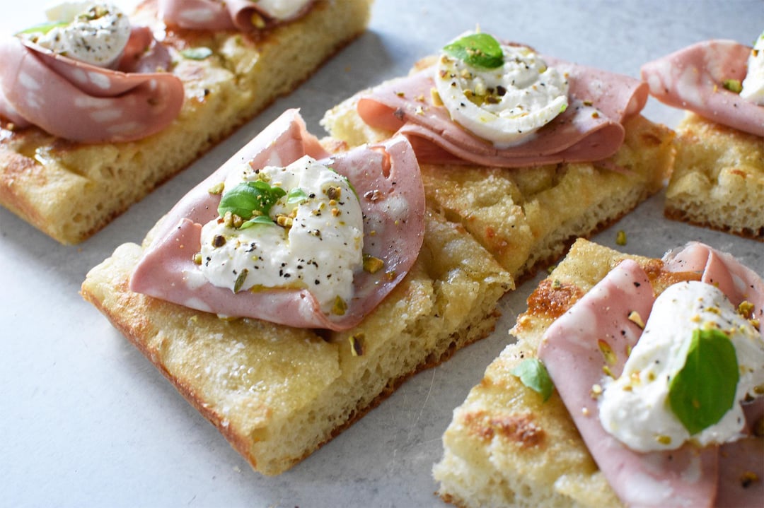 Focaccia with mortadella, burrata, pistachio, basil, EVOO, sea salt