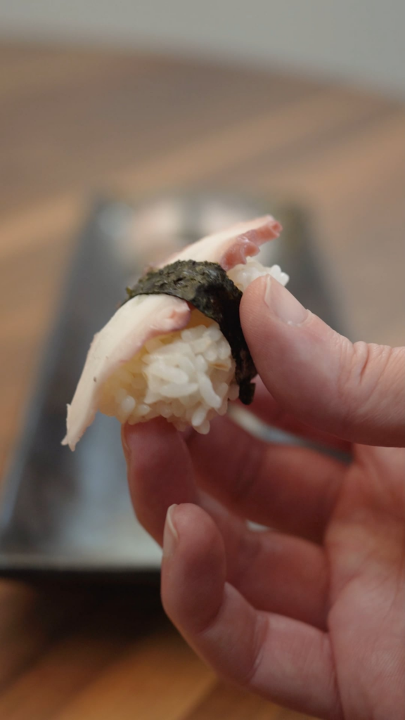 Breaking down an octopus tentacle for Nigiri Sushi