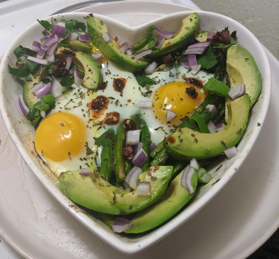 Roasted asparagus, red chard & onions, topped with eggs, herbs, avocado & chili crisp