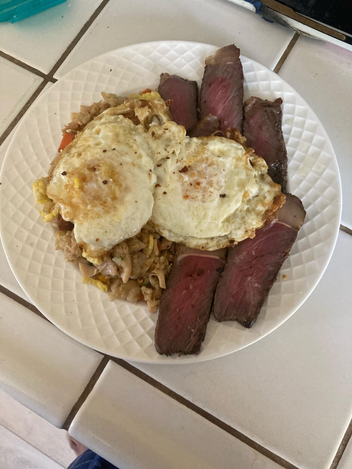 Fried Rice and Steak with an egg on it