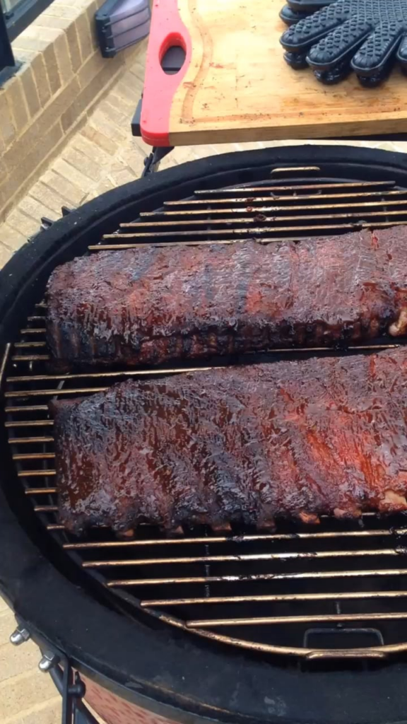 Beautiful smoked BBQ ribs being smothered in apple sauce.