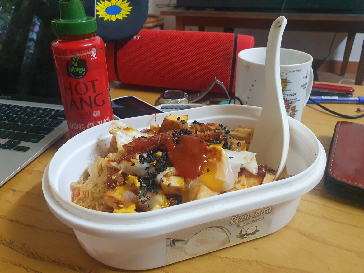 Mixed xoi, topped with tofu, shallots, garlic, sesame seeds and crowned with a fried egg.