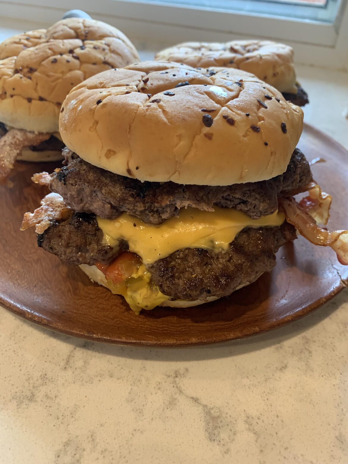 Homemade bacon cheeseburger on onion bun