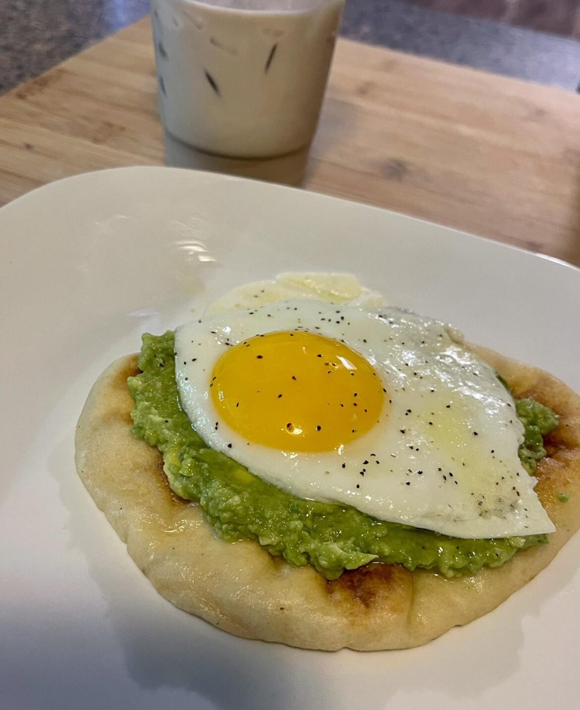 Garlic Naan, avocado and a sunny side up egg.