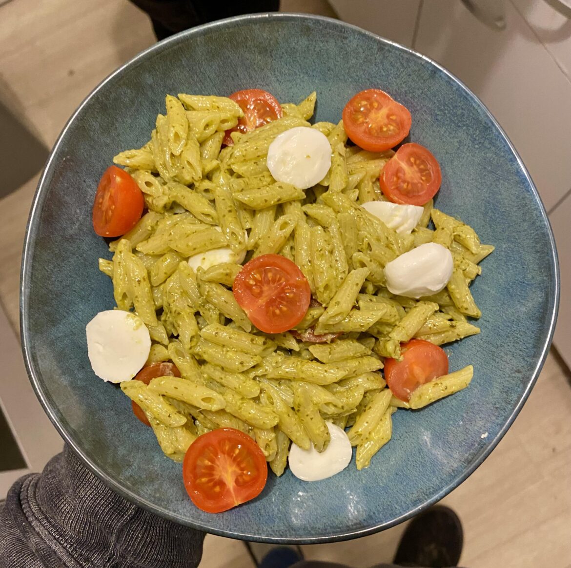 Pesto pasta with cherry tomatoes and mozzarella