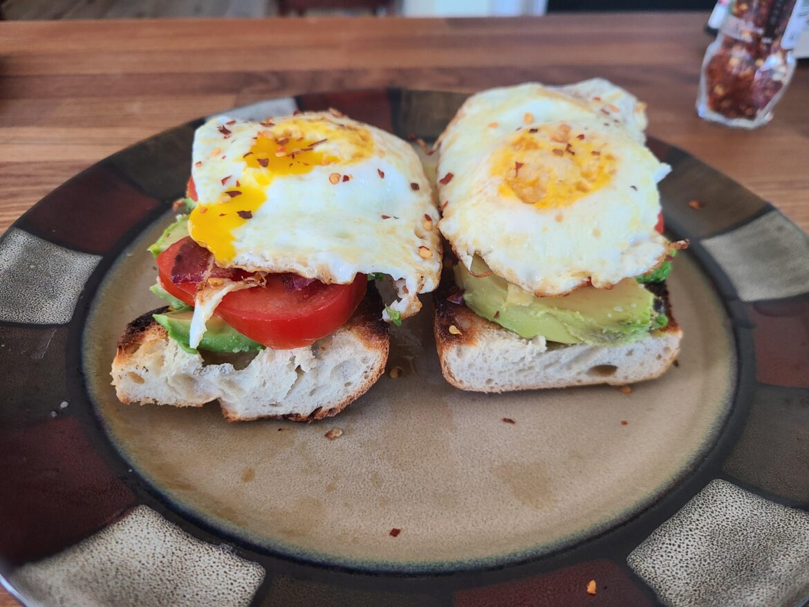 Avocado toast with bacon and tomato