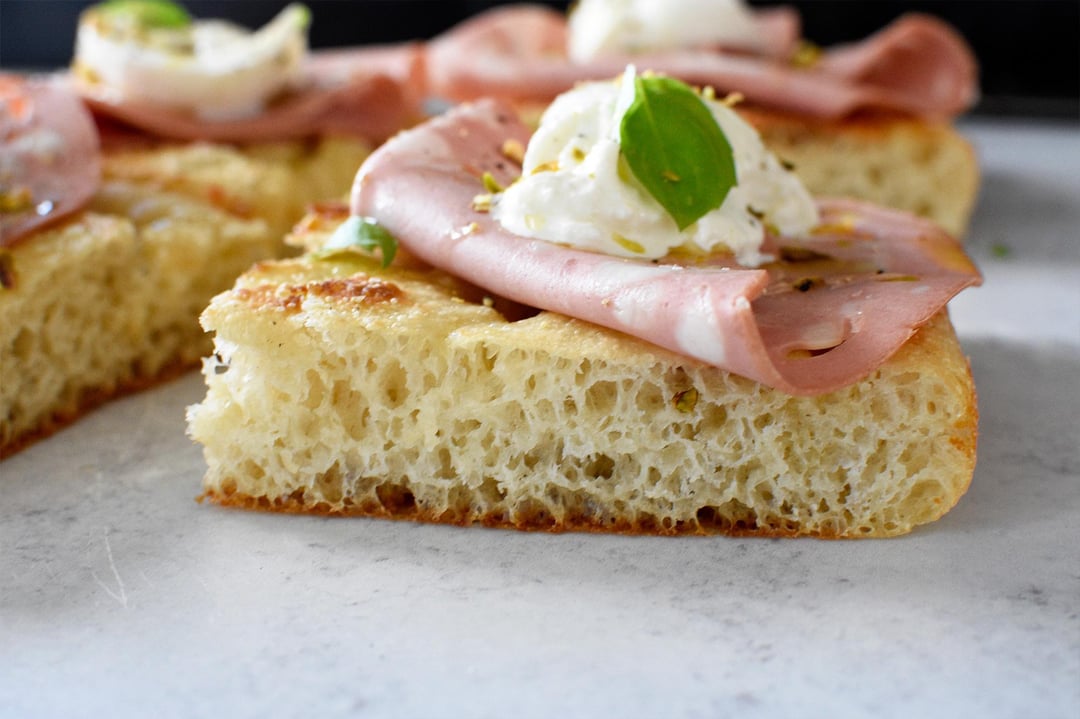Focaccia with mortadella, burrata, pistachio, basil, EVOO, sea salt
