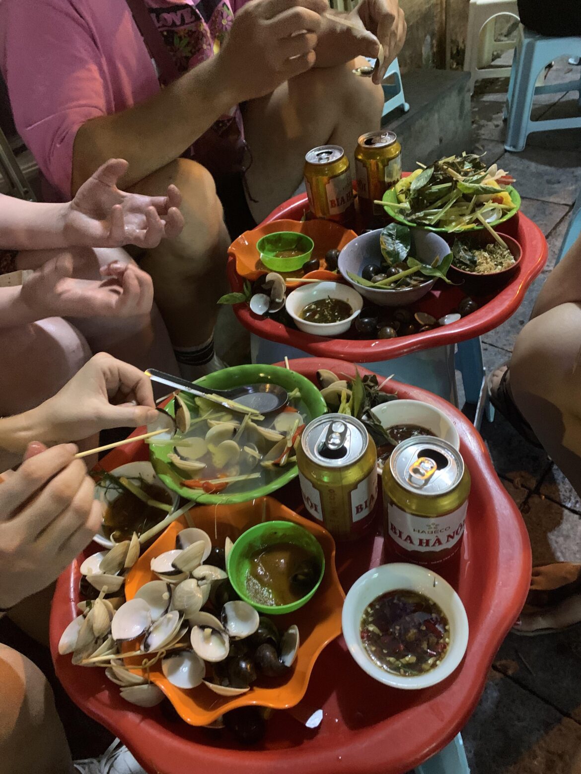The end product of when a group of foreigners come and try Oc and clams from a little restaurant in the streets of the Old Quarter in Hanoi, Vietnam.