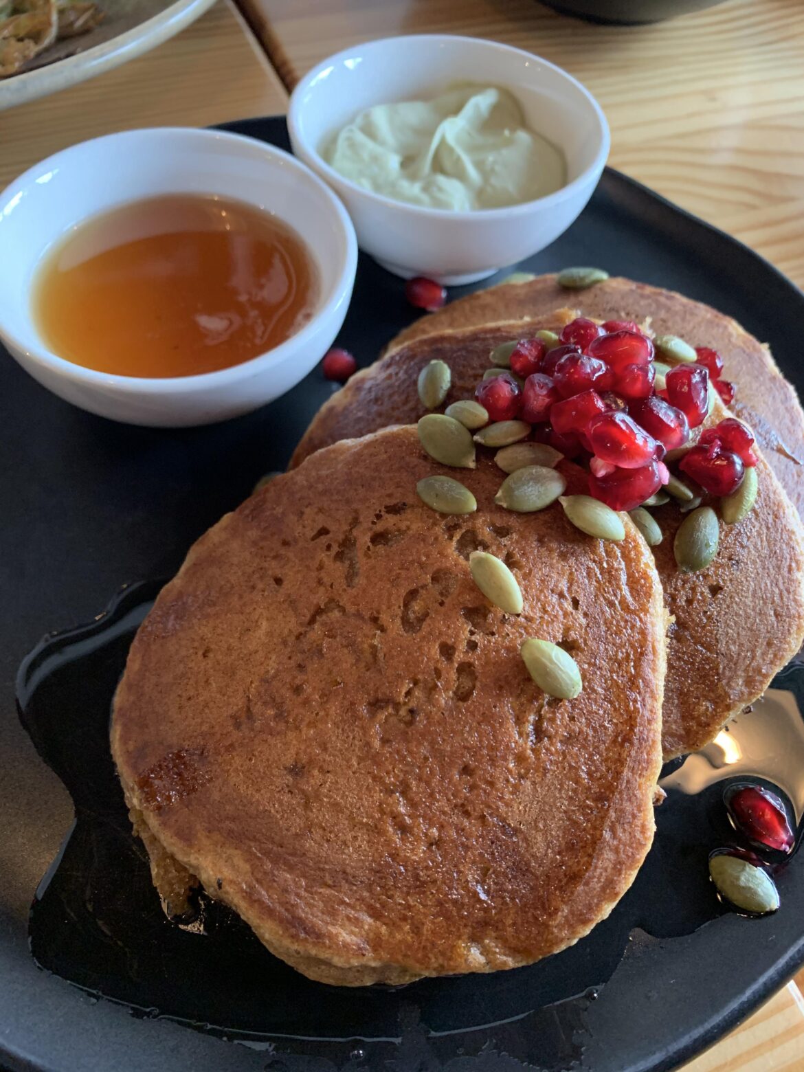 Brunch at Marrow. Pumpkin pancakes with coconut cream and pomegranate.