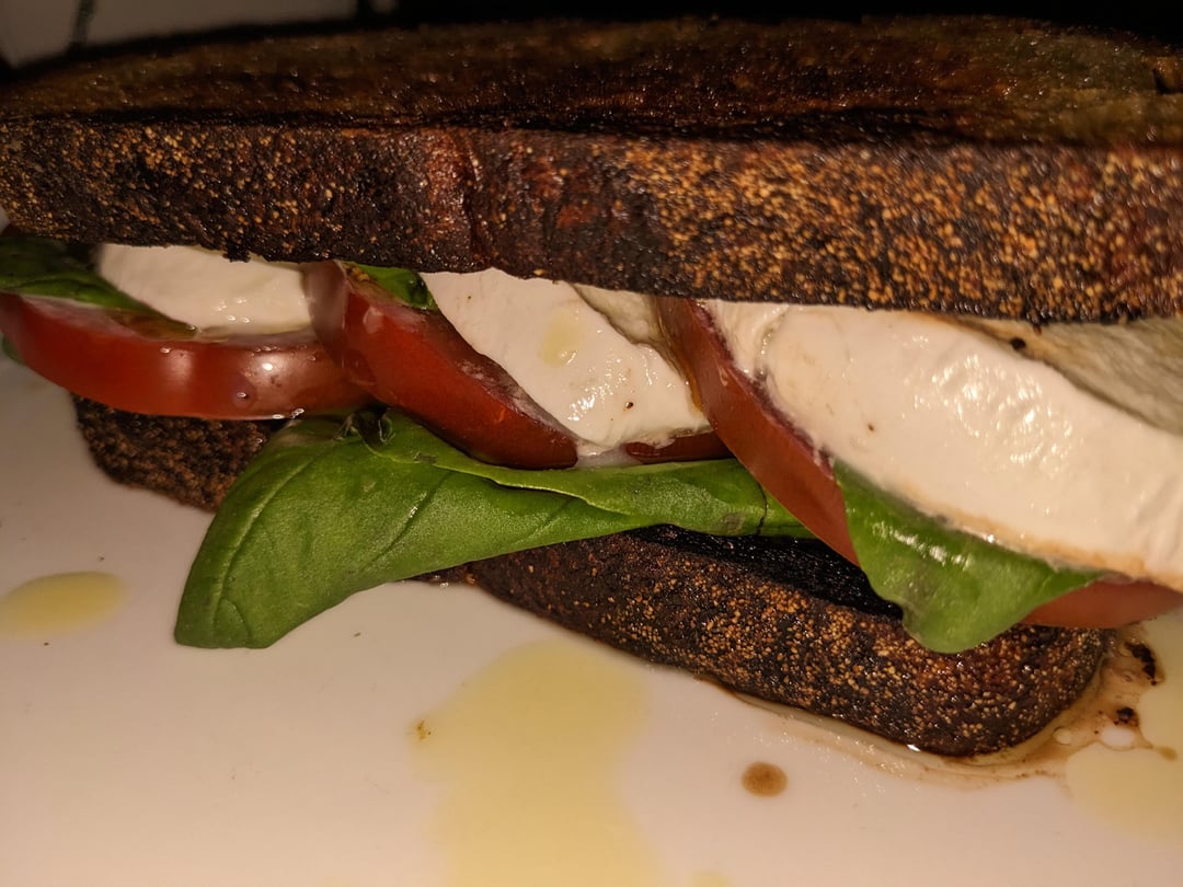 Caprese sandwich. Heirloom tomatoes drizzled in balsamic vinegar