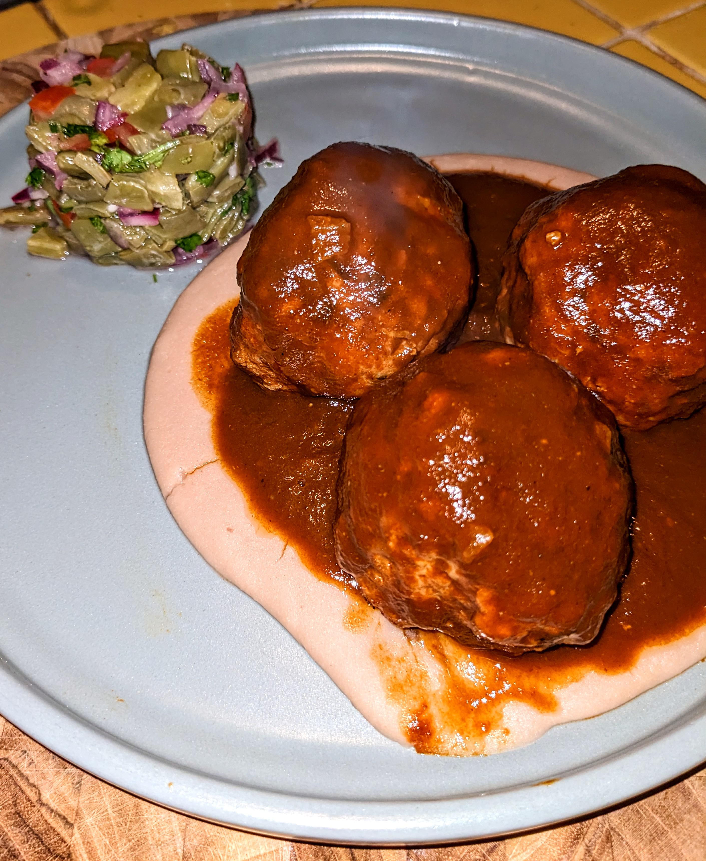 Hard boiled egg stuffed meatballs with spearmint in pasilla salsa with
