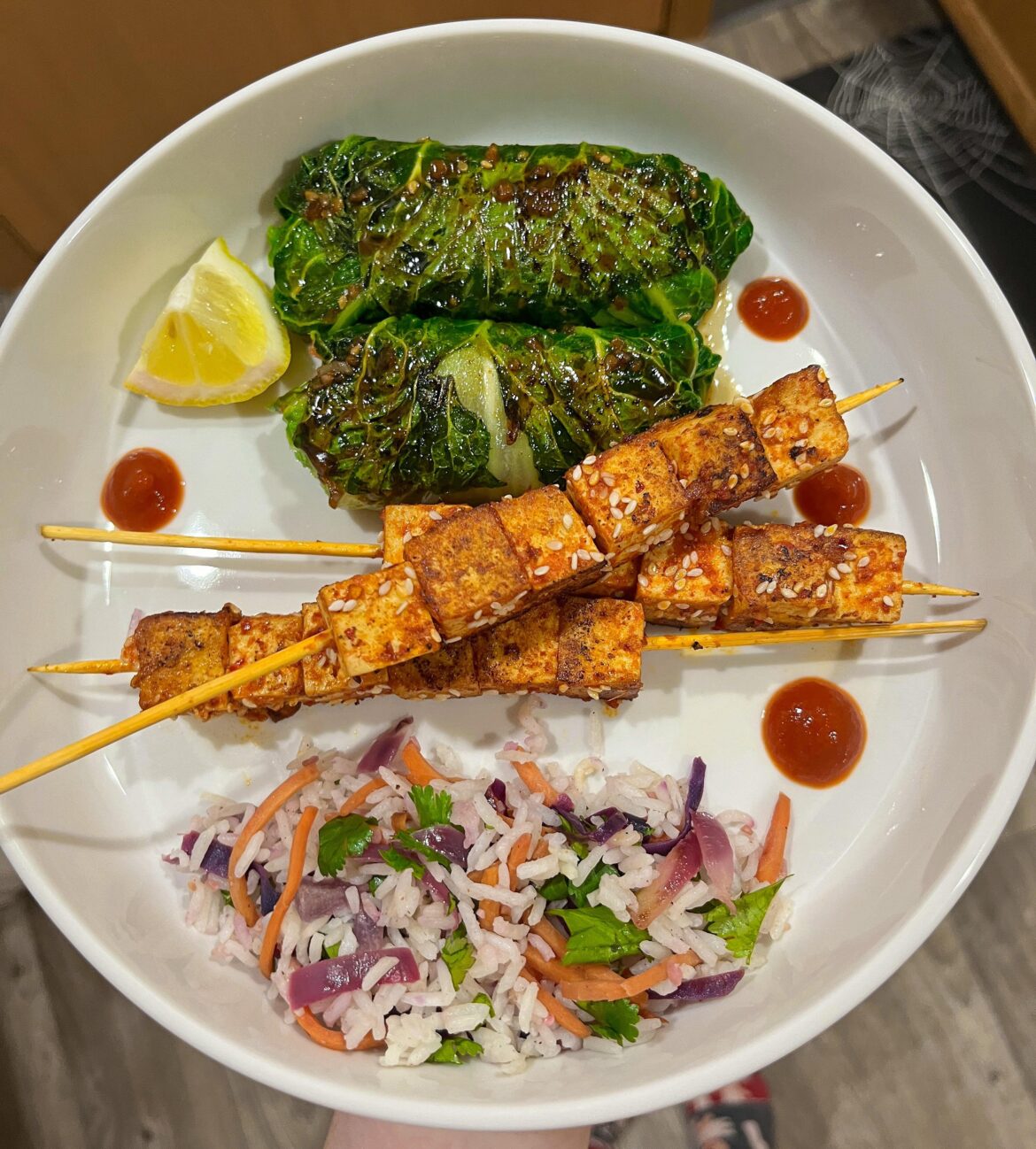 Spicy bulgogi tofu skewers, teriyaki napa cabbage rolls, with a side of cilantro lime jasmine rice and mixed vegetables