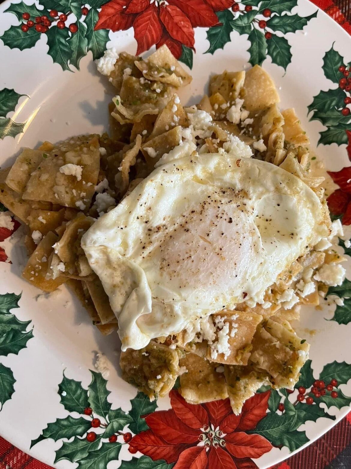 Homemade Chilaquiles with Salsa, Cheese And A Fried Over-Easy Egg On Top. 🍳