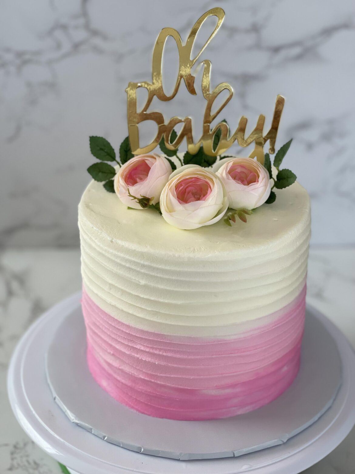 A simple two tone cake I made with non edible flowers and a cake topper
