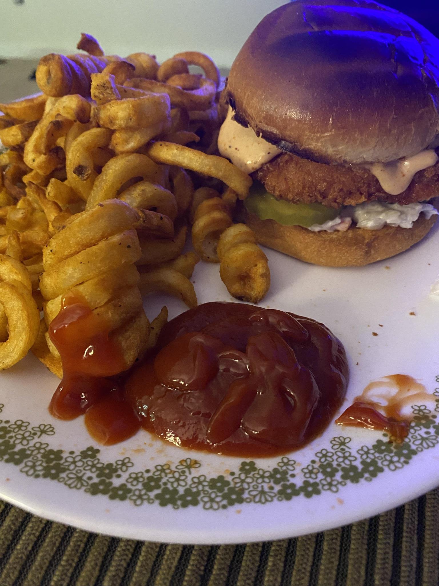 Fried chicken on a toasted brioche bun with pickles coleslaw and