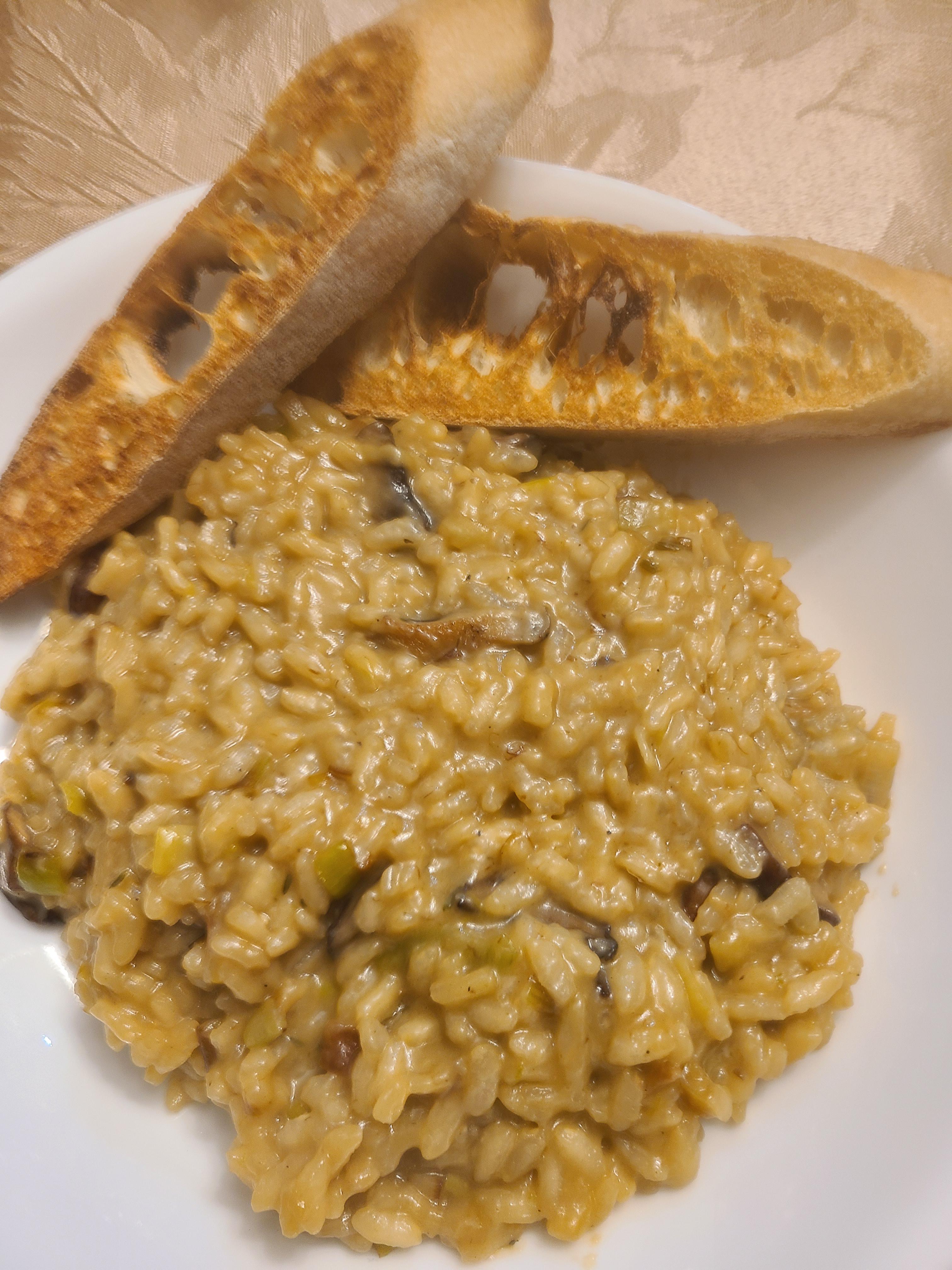 Mushroom and leek risotto with French bread. Dining and Cooking