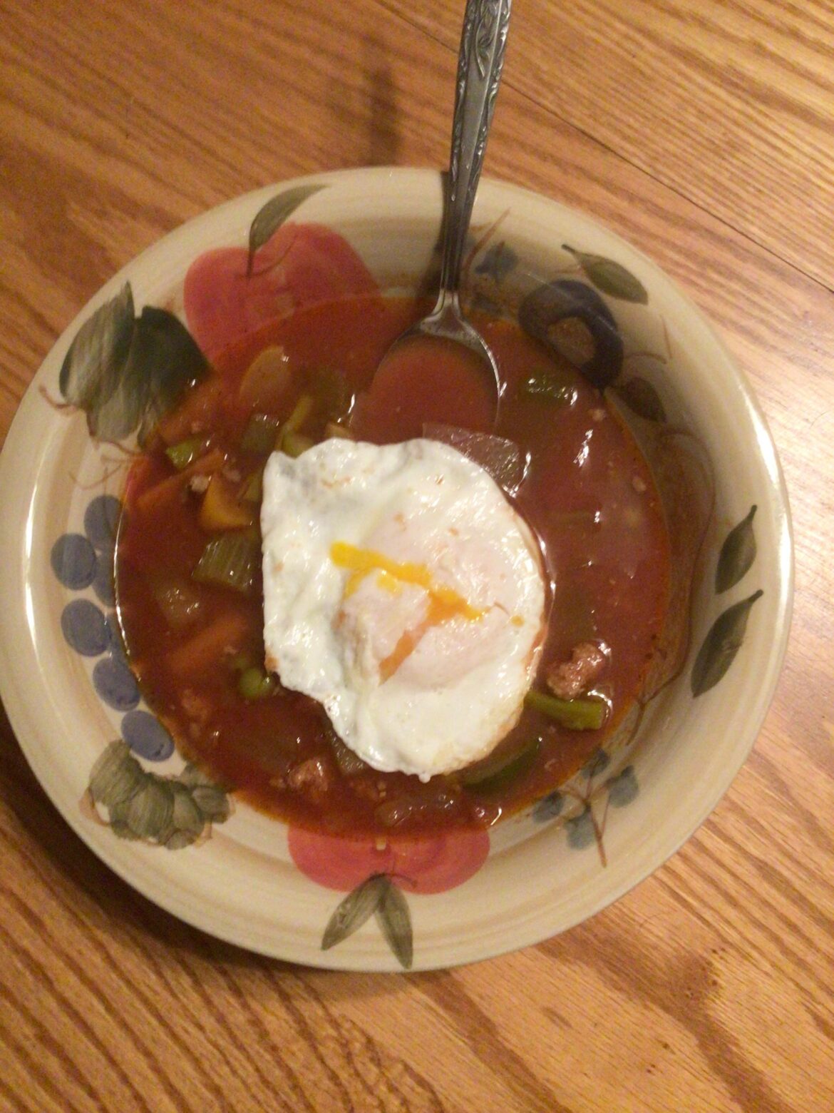 Leftover beef vegetable soup with an over easy egg on top.