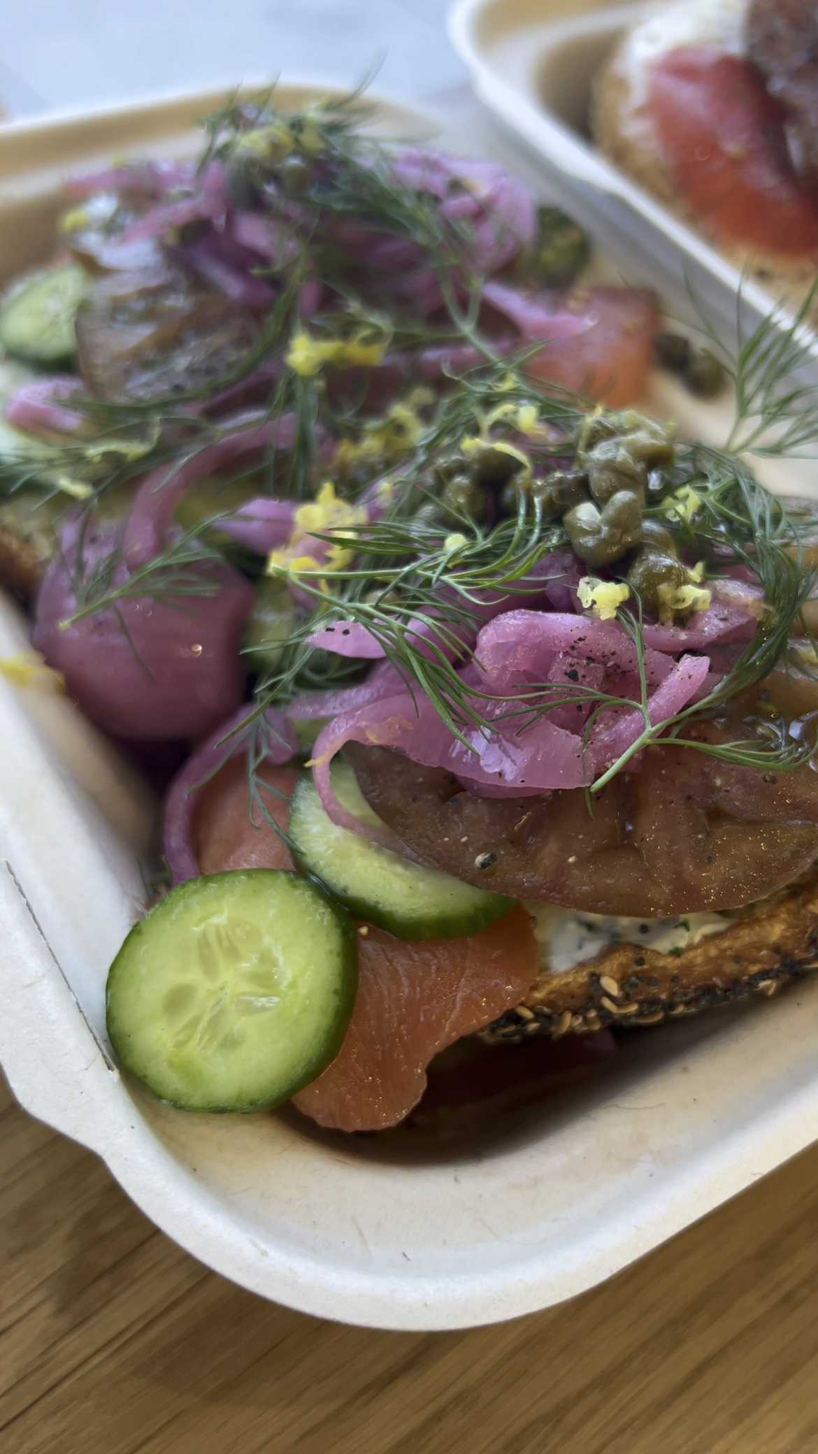 Layla bagels. THE LAIKA smoked salmon, tomato, cucumber, pickled onion, capers with herb cream cheese. THE SCARLETT heirloom tomato, lemon zest, chili flakes with cream cheese
