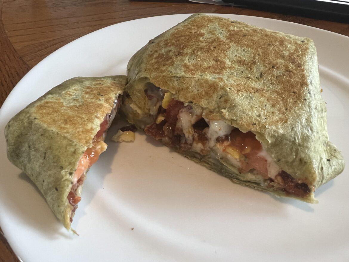 Breakfast Crunchwrap Supreme (scrambled eggs, bacon, 2x white American cheese, tomatoes, ketchup, salsa, on a spinach wrap)