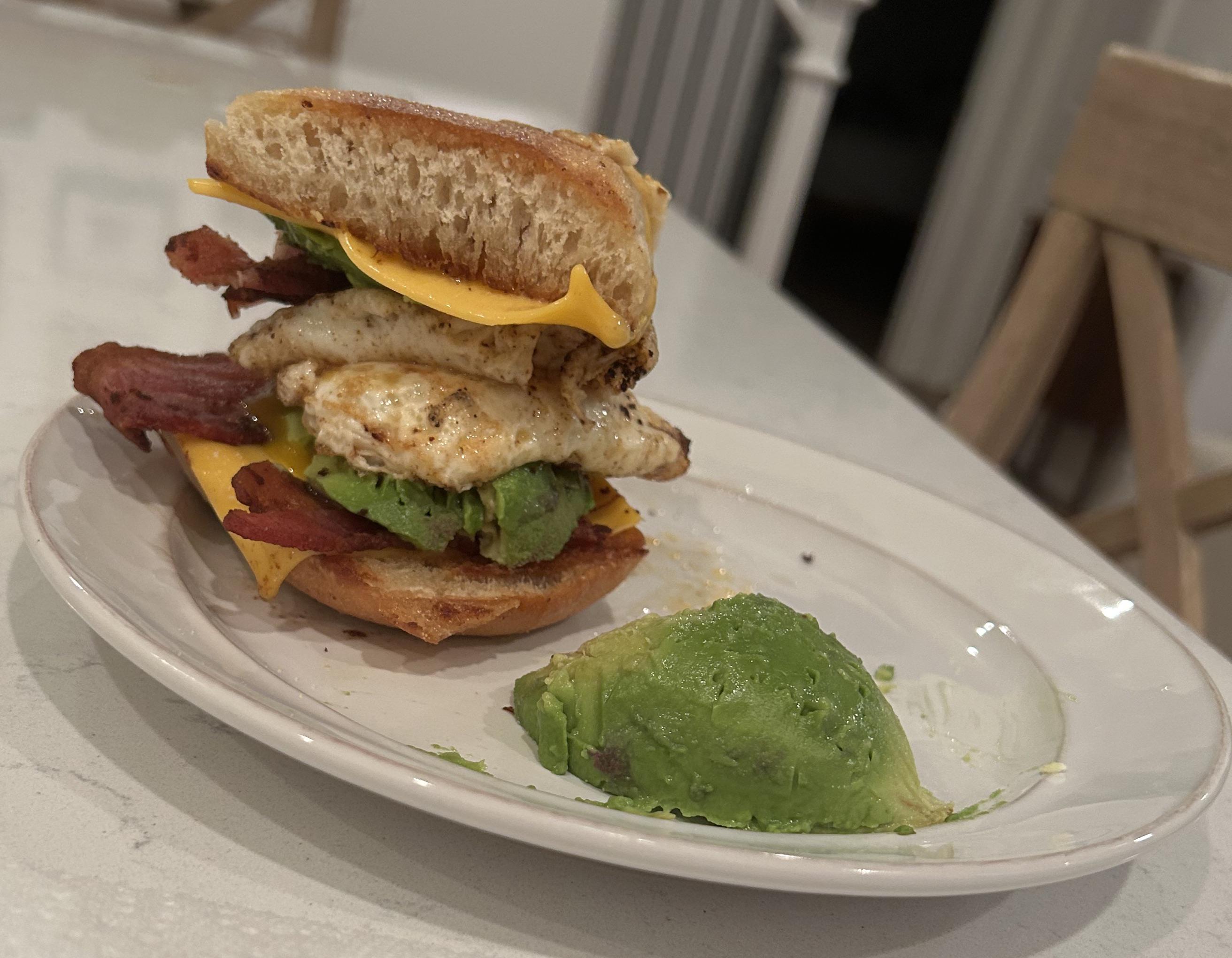 A little munchies breakfast sandwich with bread and eggs fried up in bacon grease. Dining and