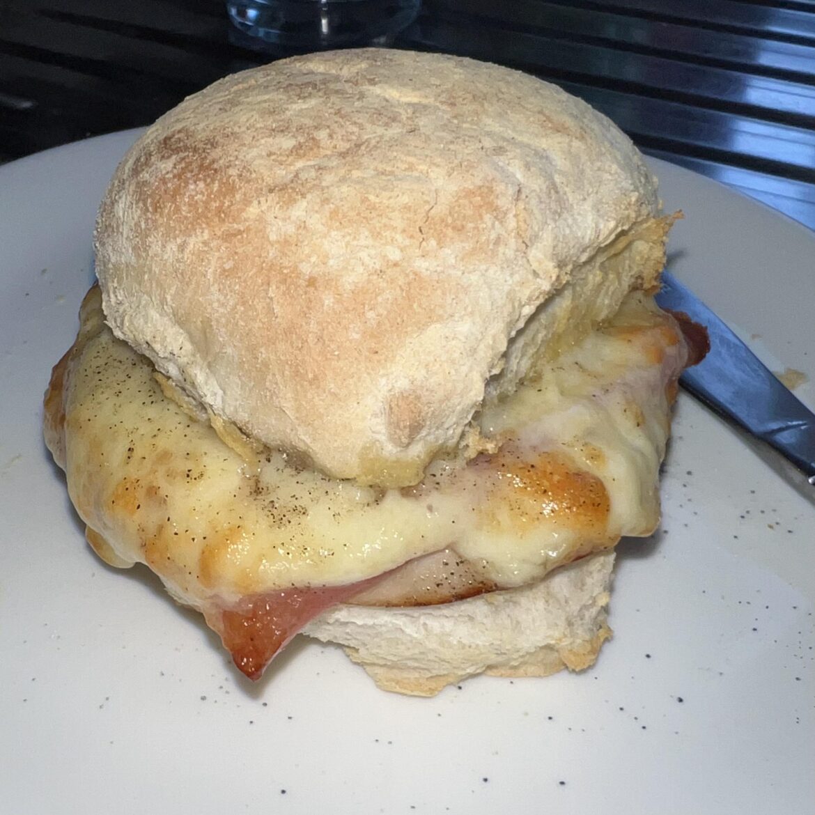 Chicken, ham and cheese toasted roll with butter and pepper