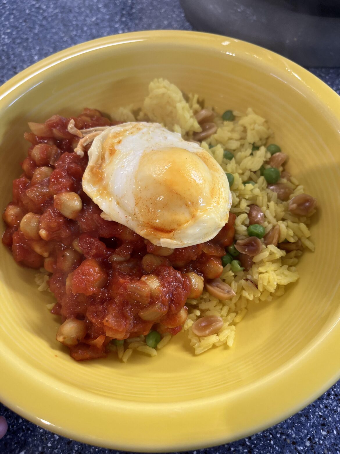 Garbanzo stew and peanut rice, egg poached in a light shaking of turmeric