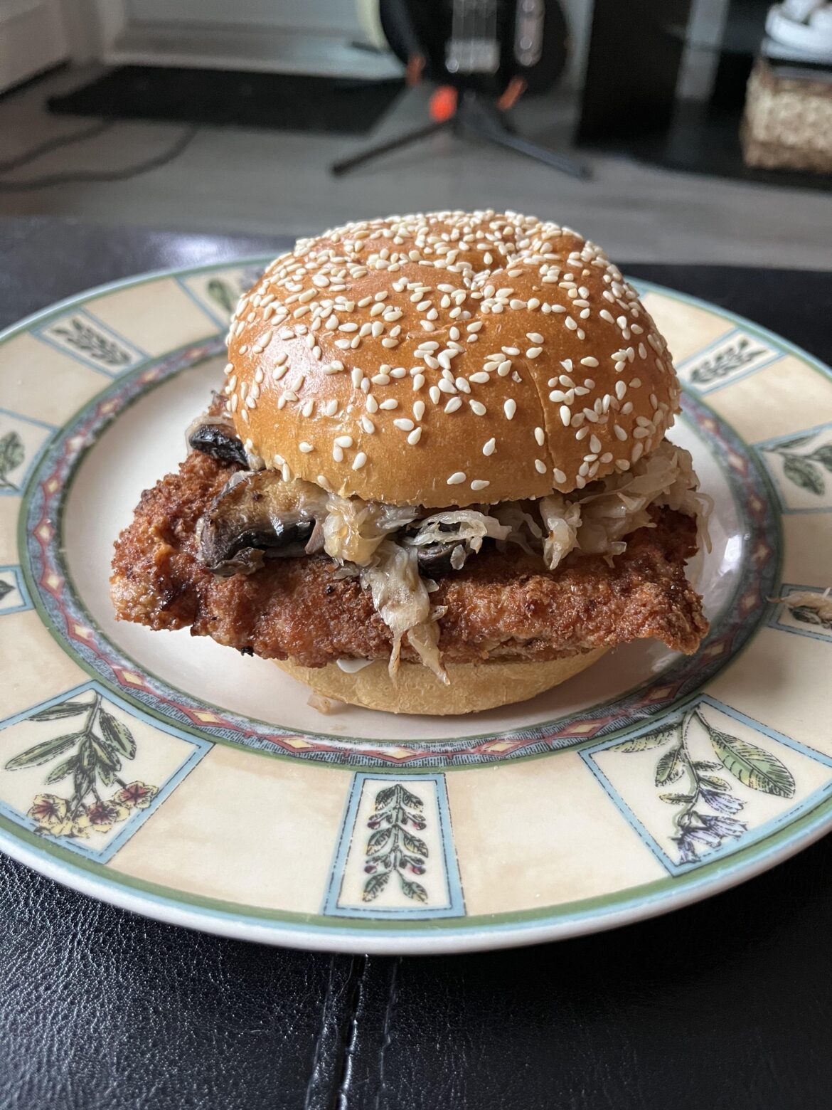 Pork Schnitzel Sandwich with Sautéed Mushrooms, Sauerkraut, Mayo and Honey Mustard.