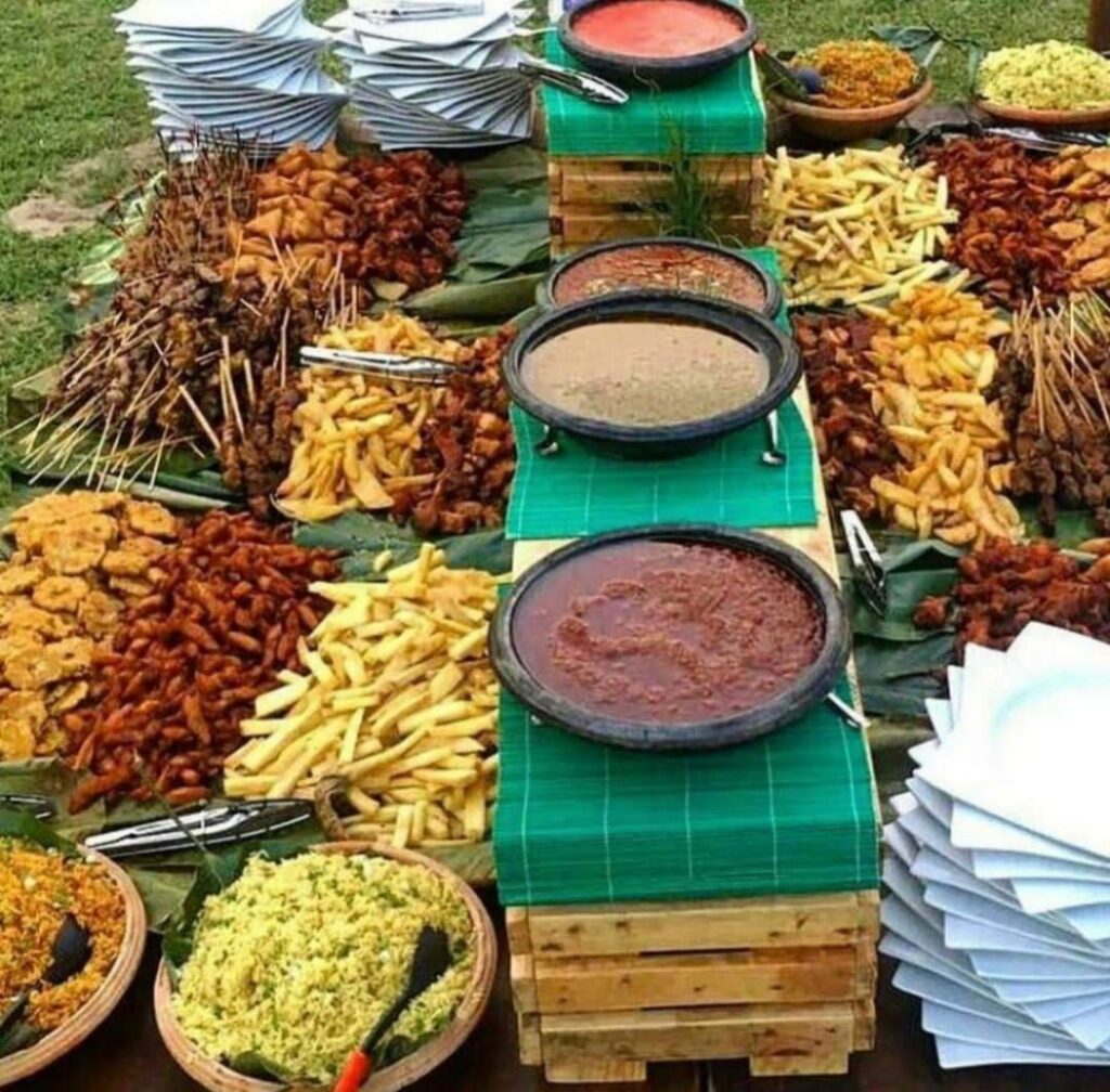 A typical African Buffet with fried yams, plantains, khebabs, jollof rice, fried rice and various grinded peppers ~ Accra, Ghana