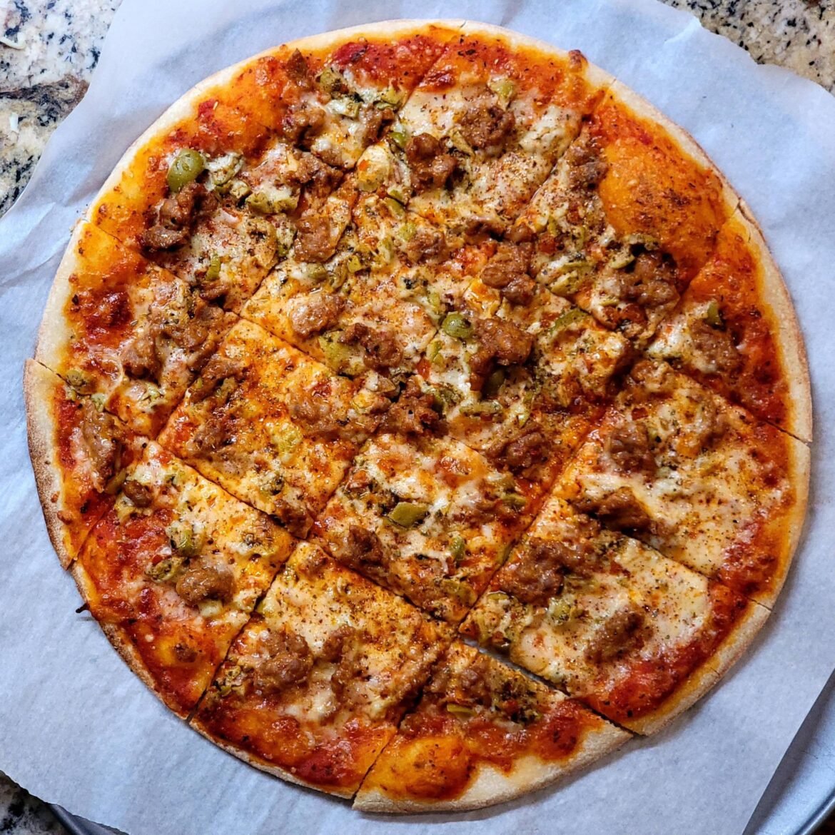 Chicago tavern style thin crust with Italian sausage and olive tapenade