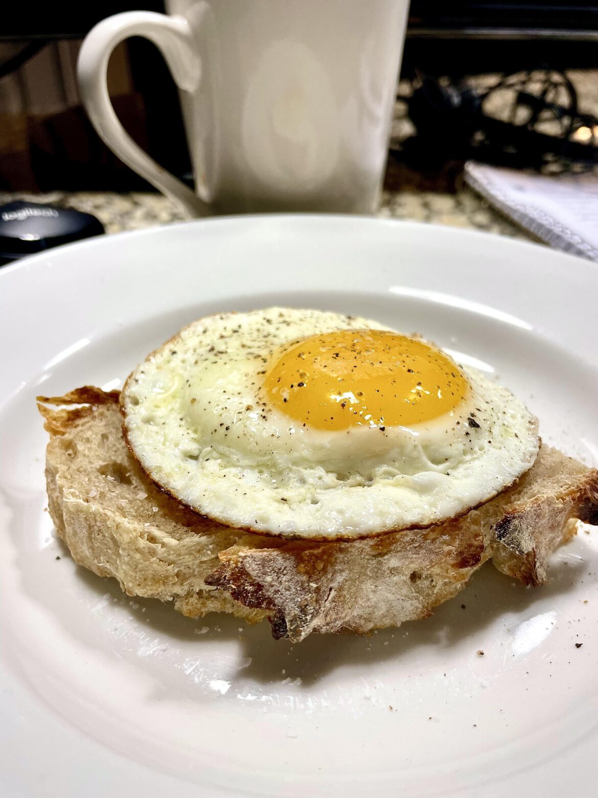 Toasted homemade sourdough, an egg on it, sea salt flakes and fresh black pepper.