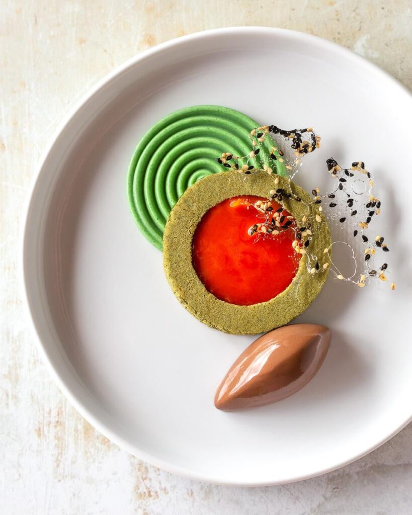 Chocolate Crémeux with Brown Butter Gochujang Caramel, Matcha Sponge, Matcha White Chocolate Ganache, and Toasted Sesame Isomalt Tuile