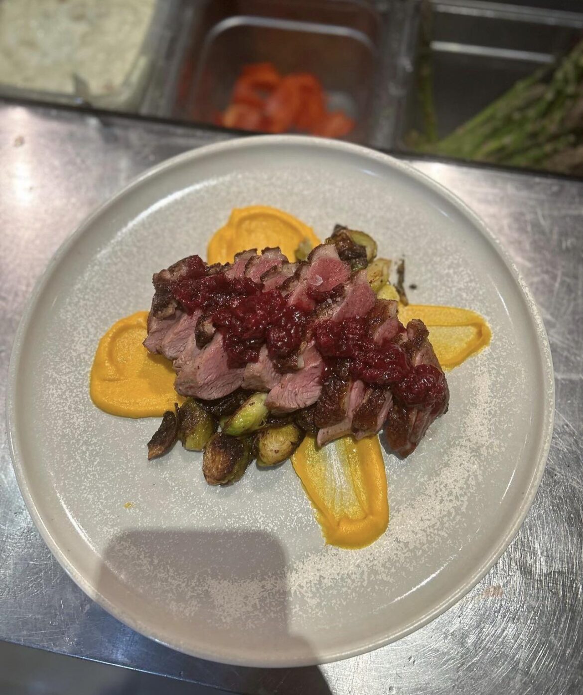 Seared duck breast w/ sweet potato purée, duck fat roasted brussel sprouts, & sour cherry chutney