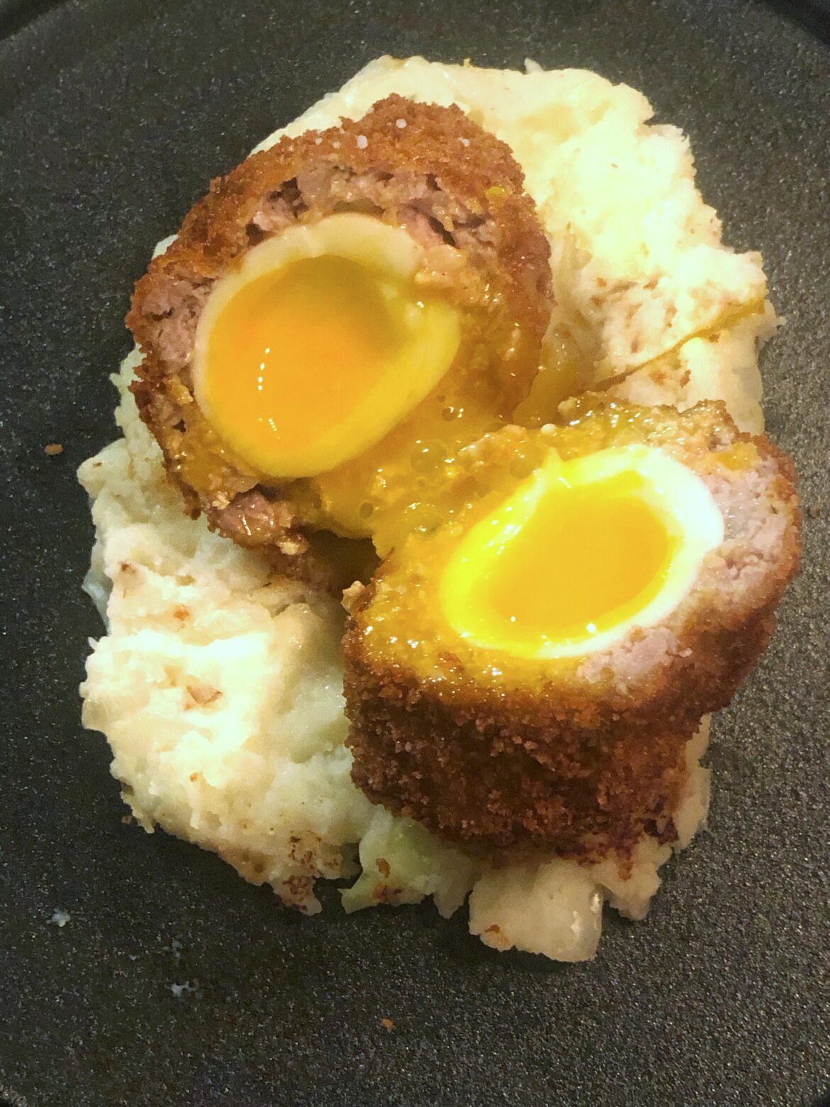 [homemade] Scotch egg with homemade sausage meat on bubble and squeak